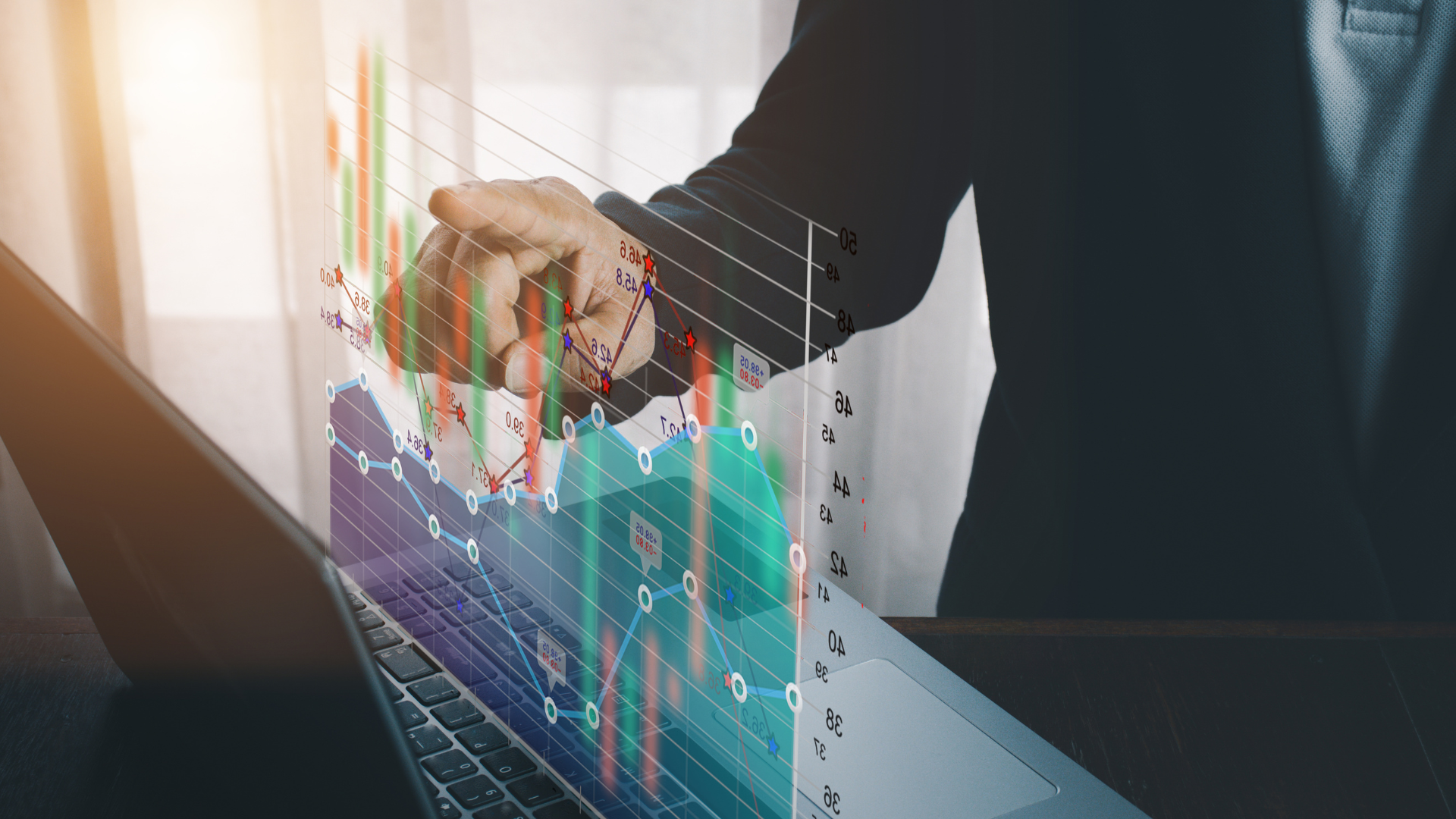 Hand pointing to futures and forex graph 