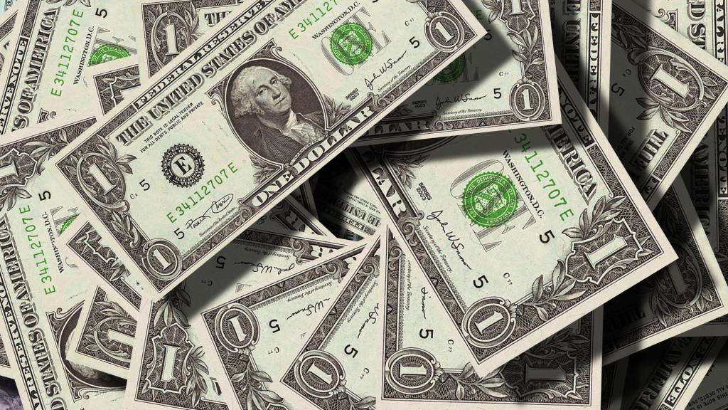 Pile of scattered U.S. one-dollar bills.