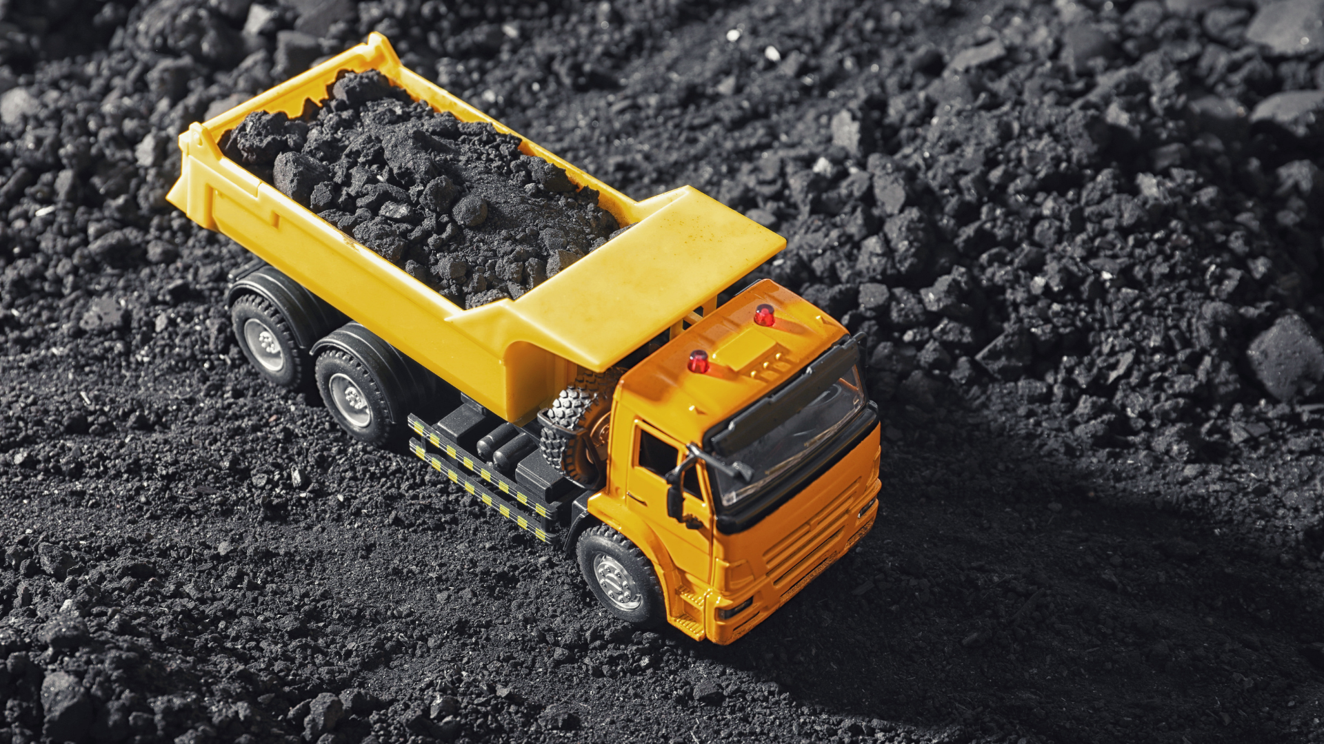 Toy Tipper Truck with Coal in Field