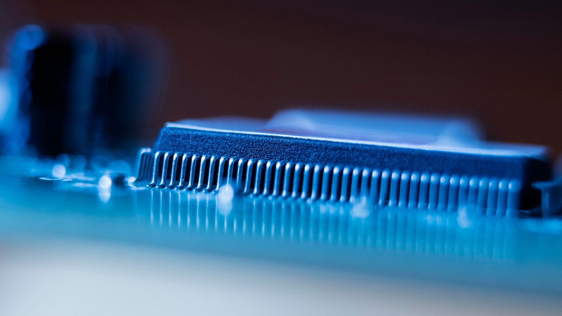 Close-up of a semiconductor chip showing integrated circuit pins and advanced microelectronics manufacturing
