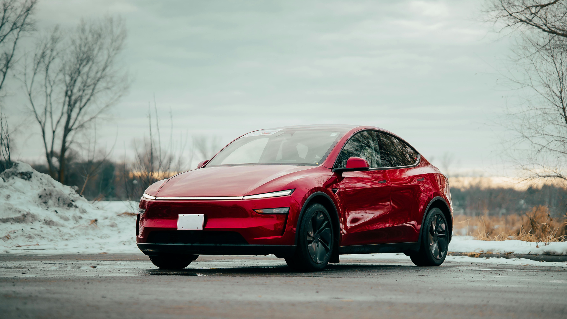 Sleek Red Electric Car in Winter Landscape