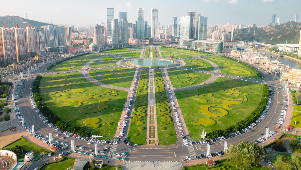 an aerial view of xinghai square with green grass