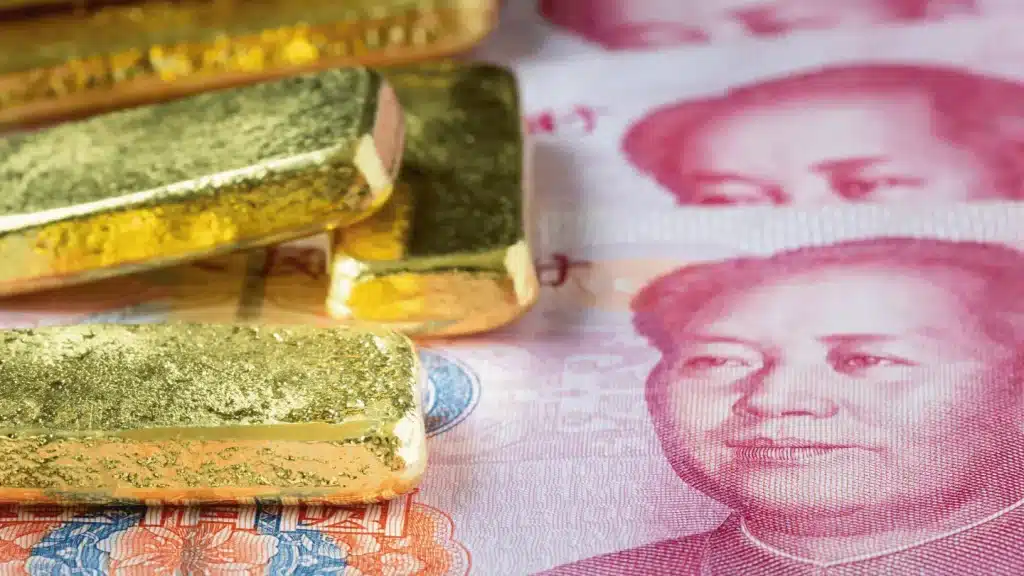 Closeup gold bar with china banknote, Stacked of gold bar with yuan for business concept