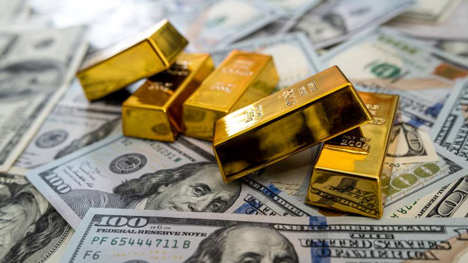 Gold bars on USD currency